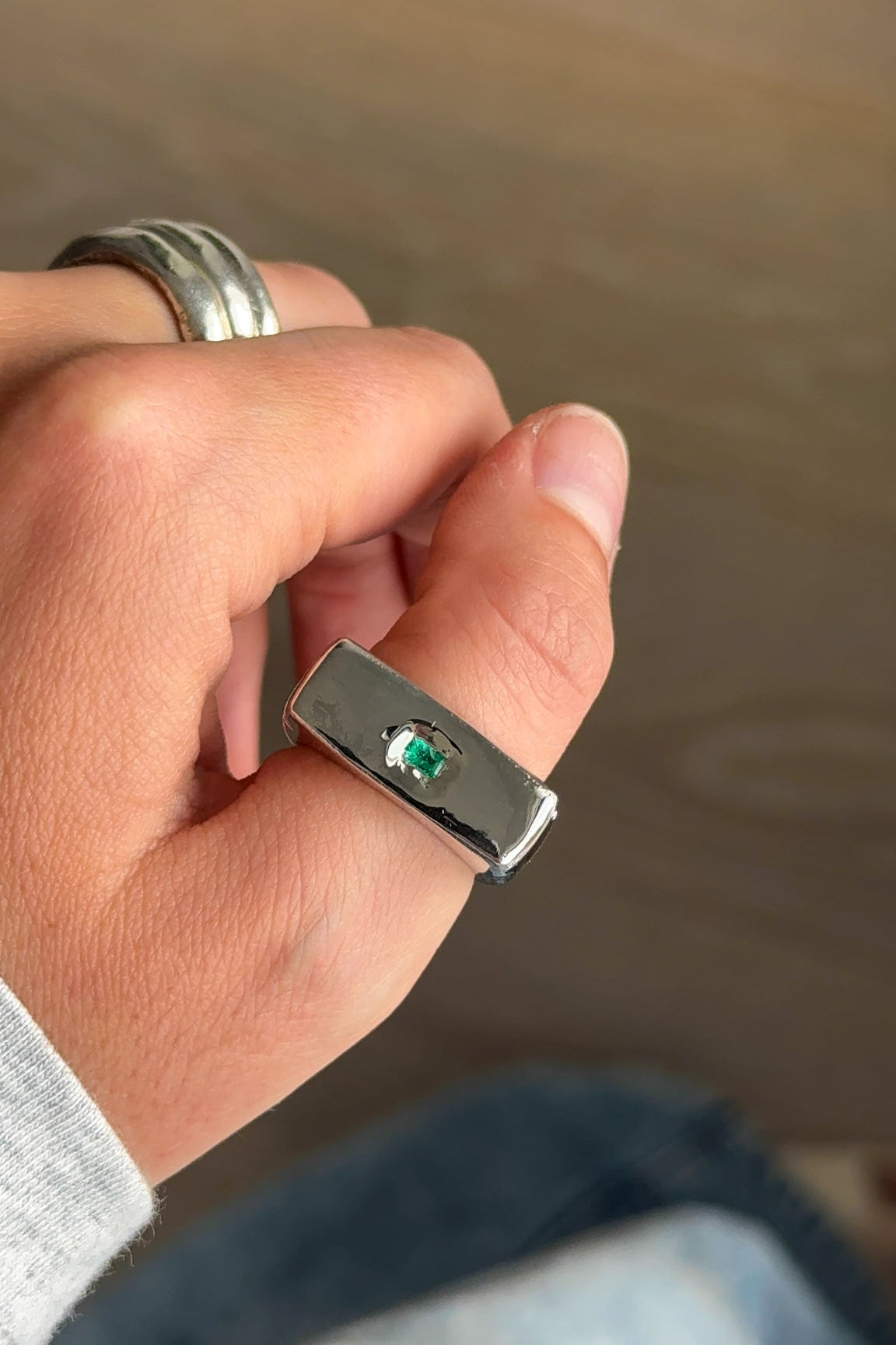 Green emerald signet ring by Sol and Mani featuring a bold 777 design, crafted in sterling silver with intricate details.