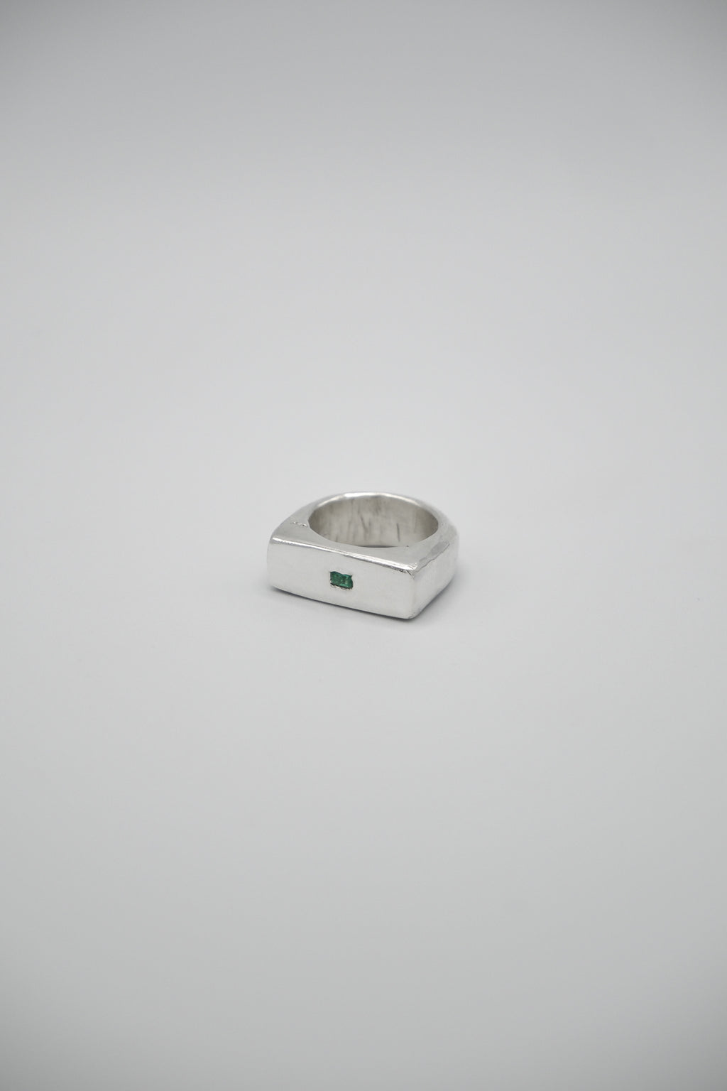 Green emerald signet ring by Sol and Mani featuring a bold 777 design, set in a sleek gold band.