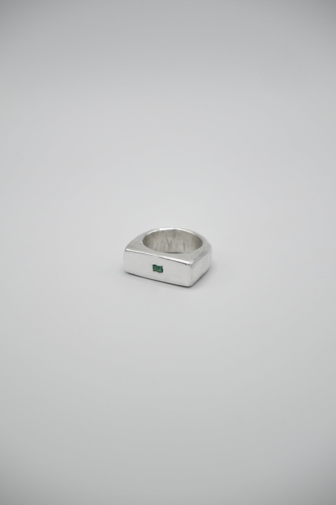Green emerald signet ring by Sol and Mani featuring a bold 777 design, set in a sleek gold band.