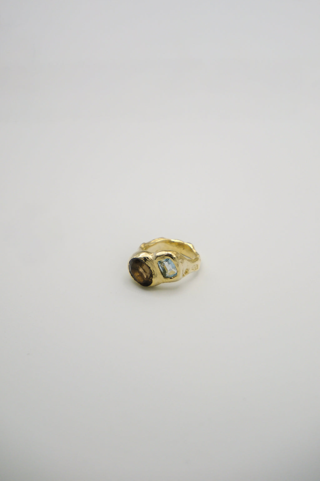 Smoky brown quartz and blue topaz ring from Sol and Mani's Daydream collection, featuring a sterling silver band and intricate design.