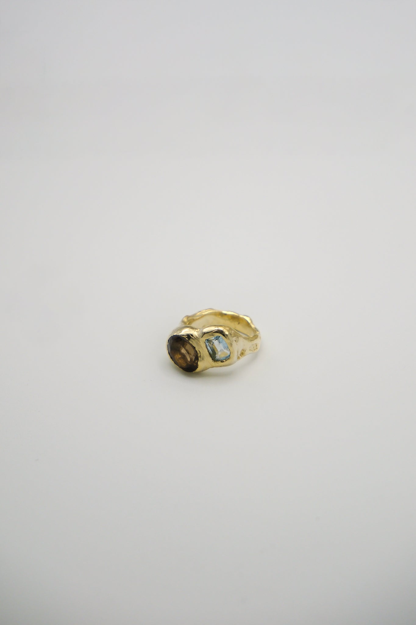 Smoky brown quartz and blue topaz ring from Sol and Mani's Daydream collection, featuring a sterling silver band and intricate design.