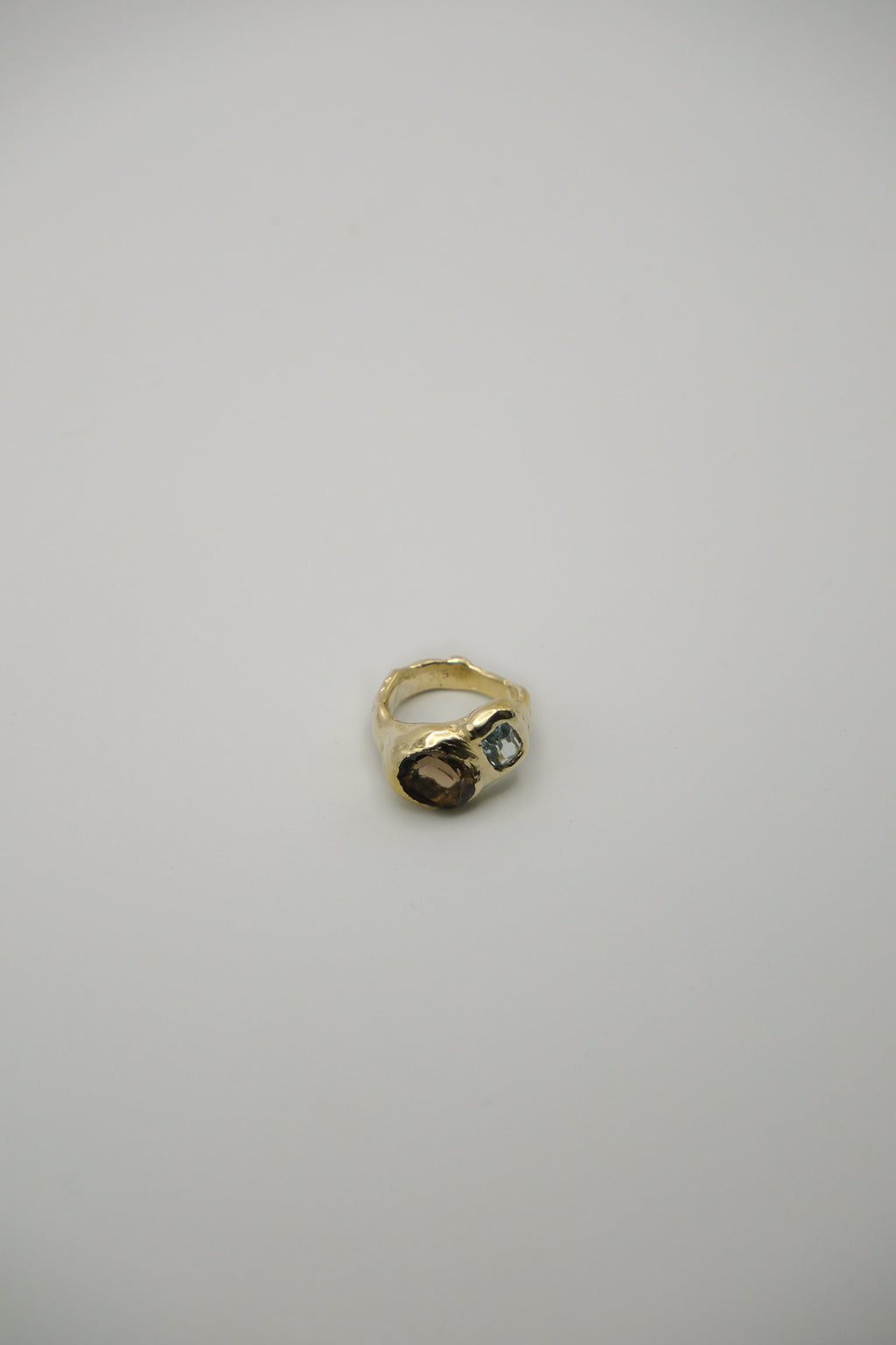 Sol and Mani Daydream ring featuring smoky brown quartz and blue topaz gemstones, set in an elegant jewelry design.
