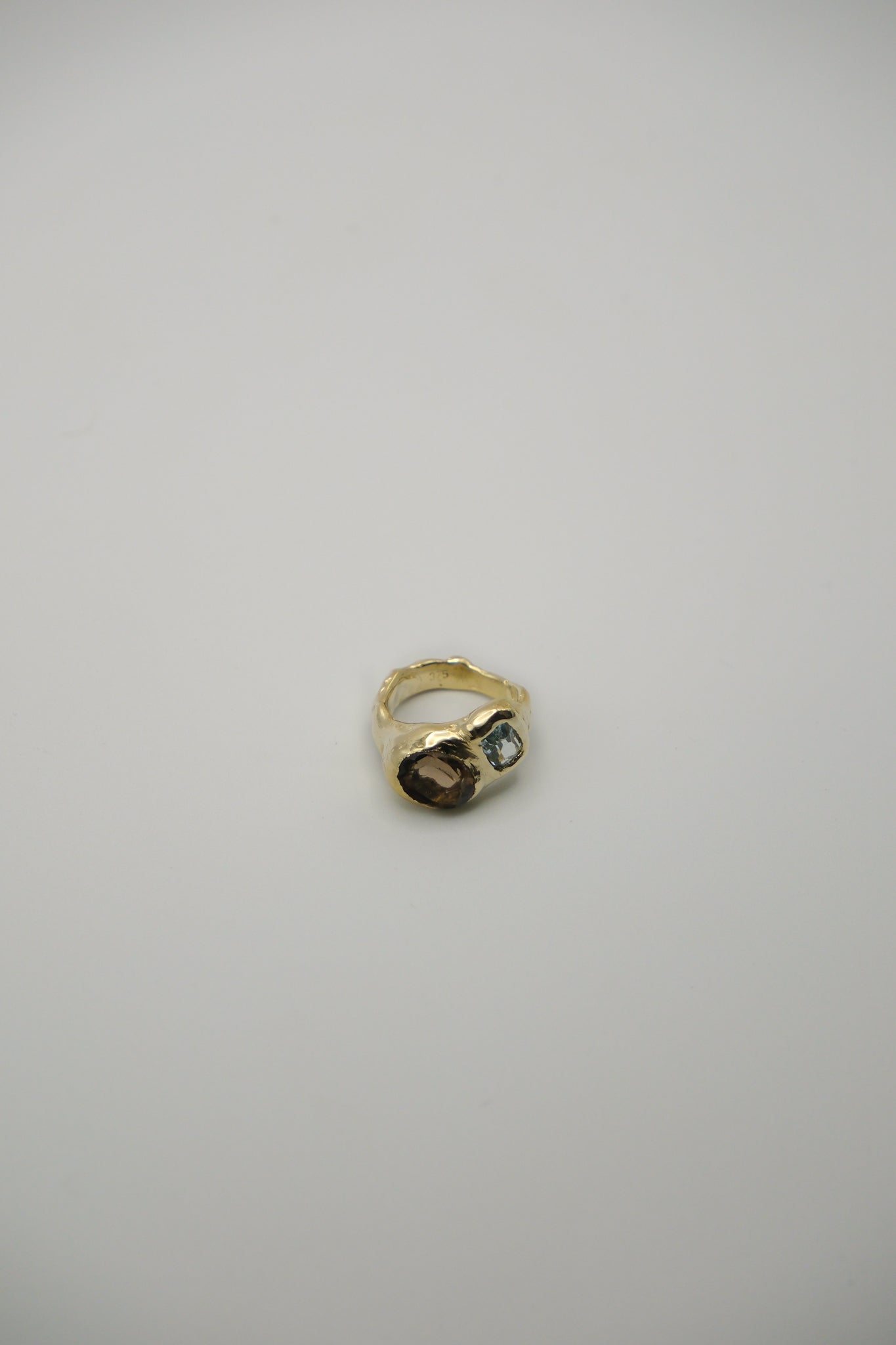Sol and Mani Daydream ring featuring smoky brown quartz and blue topaz gemstones, set in an elegant jewelry design.
