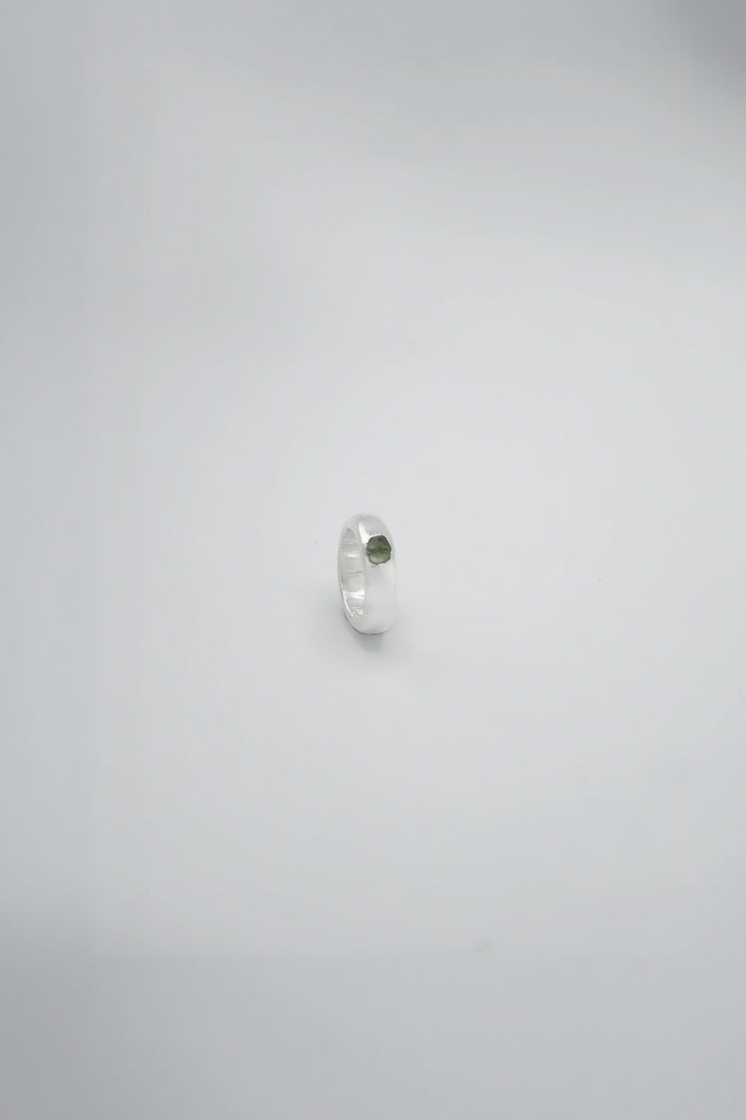 Green Moldavite crystal from Sol and Mani, shown with a textured forest-like surface and natural green hue.