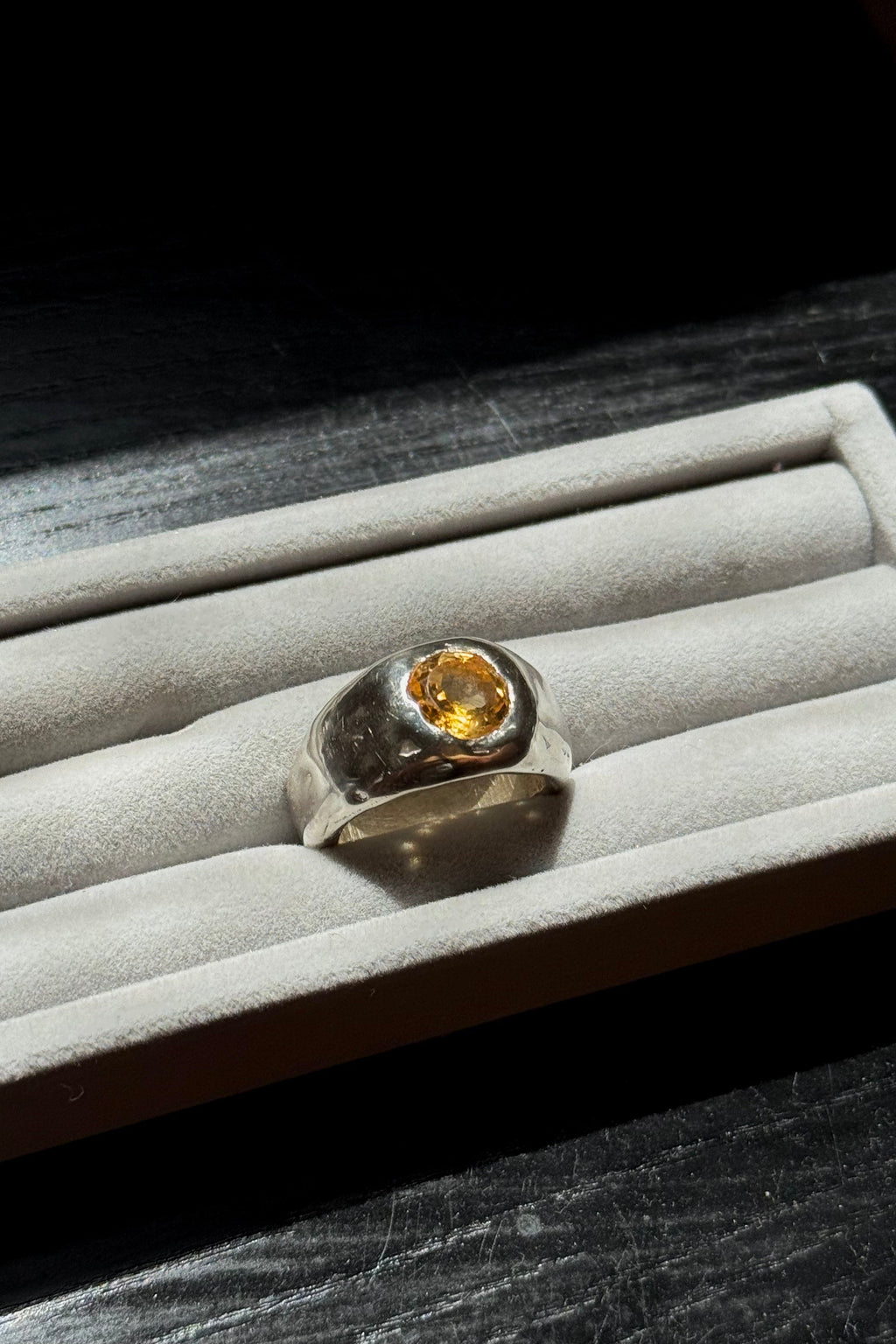Sol and Mani citrine orange stone ring featuring a large, polished citrine gemstone on a silver band.