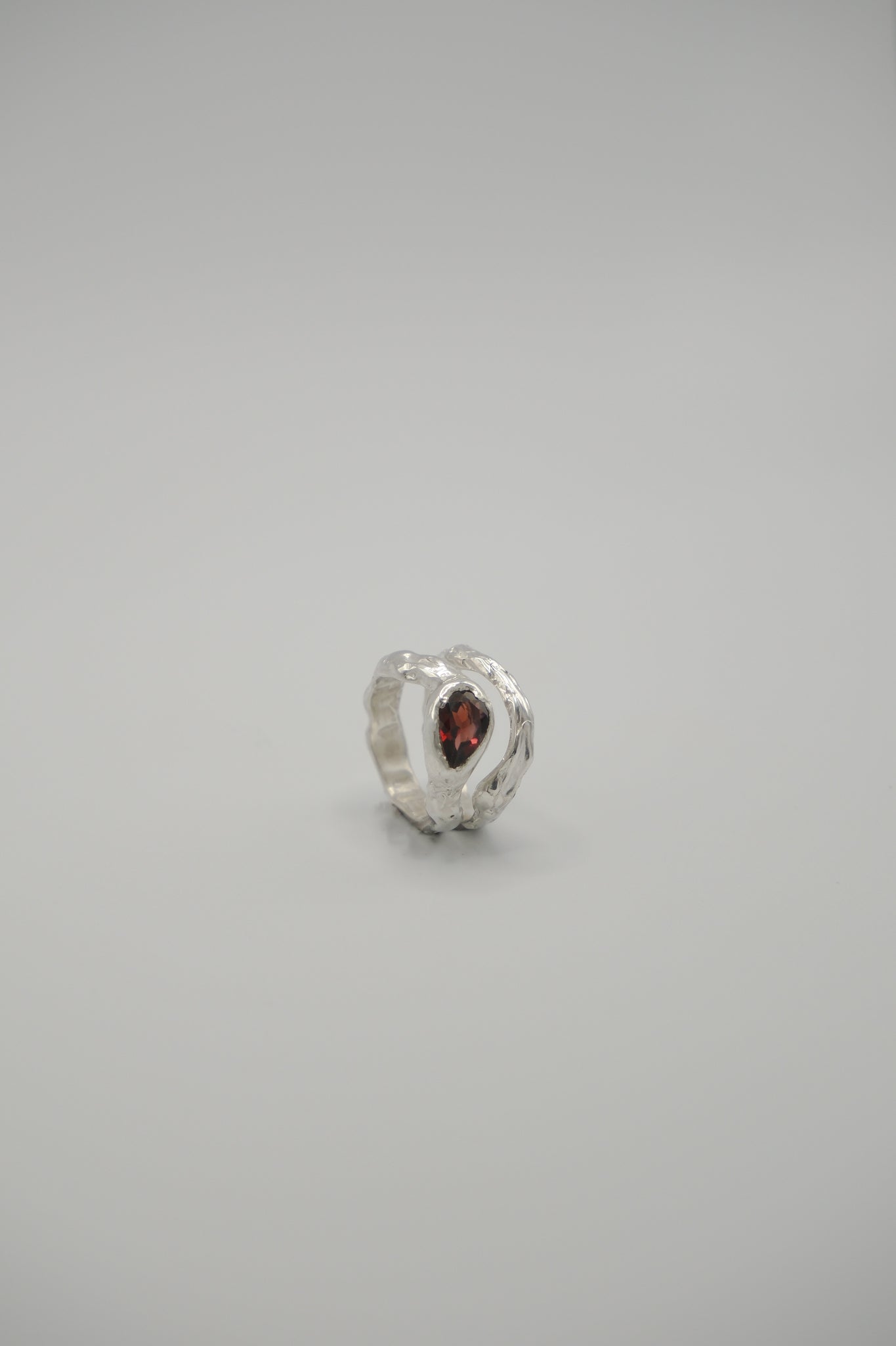 Pear-shaped Lunar gemstone by Sol and Mani, showcasing its smooth, polished surface and elegant pear cut.