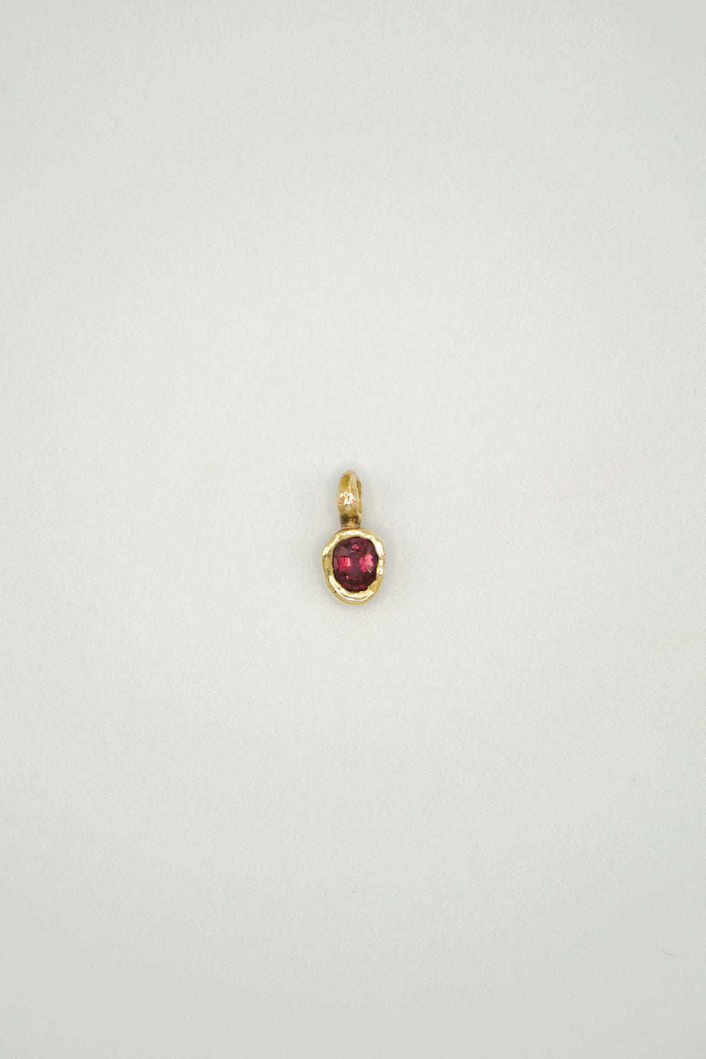 Rhodolite garnet Starling pendant with sterling silver setting, featuring a detailed bird design and vibrant red gemstone.