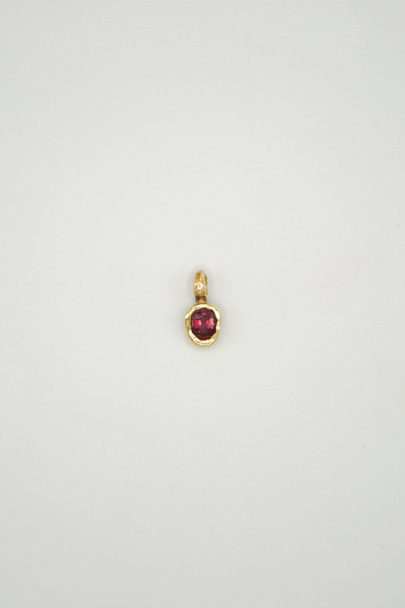 Rhodolite garnet Starling pendant with sterling silver setting, featuring a detailed bird design and vibrant red gemstone.