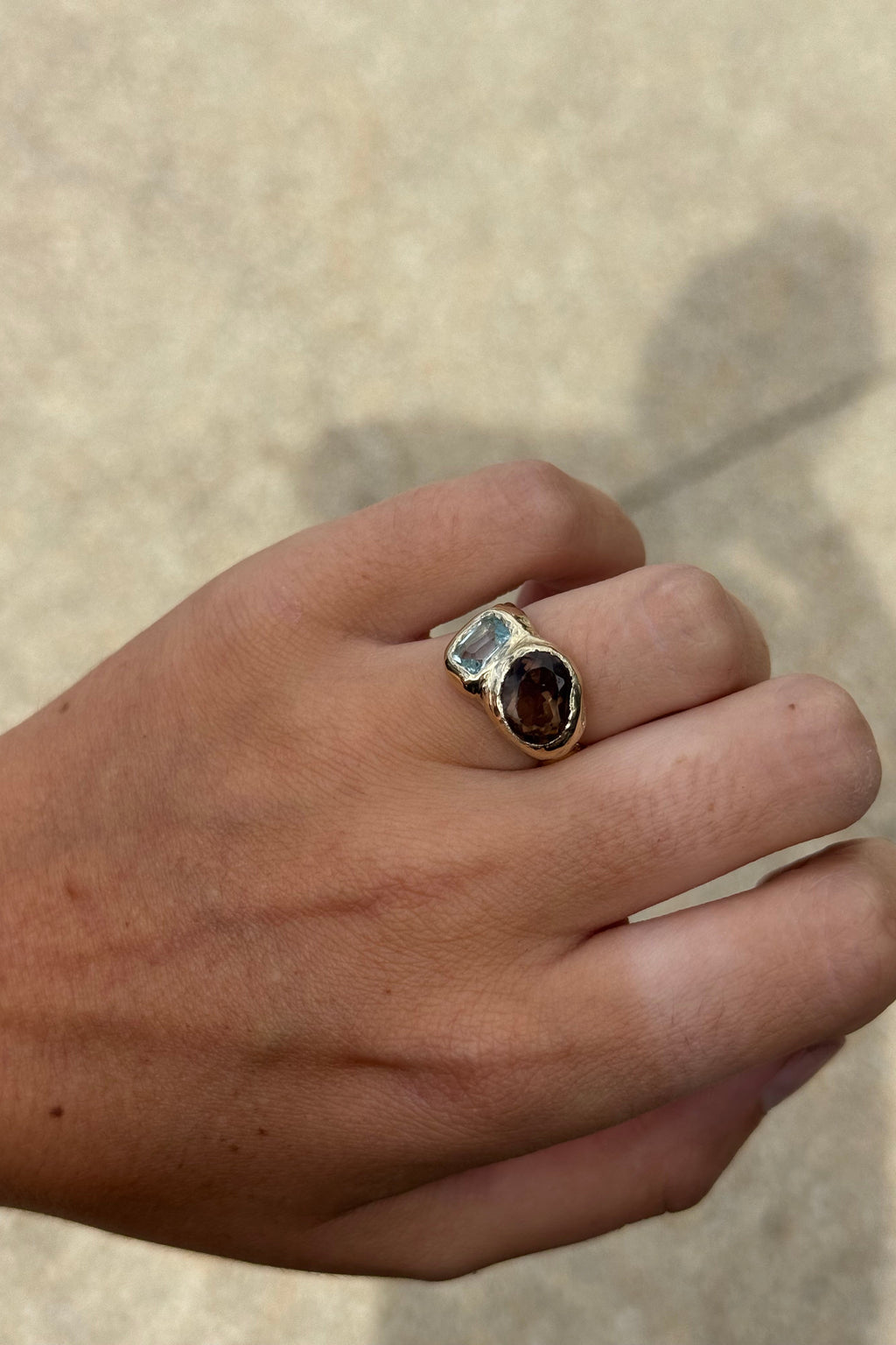 Sol and Mani Daydream ring featuring smoky brown quartz and blue topaz gemstones in an elegant gold band.