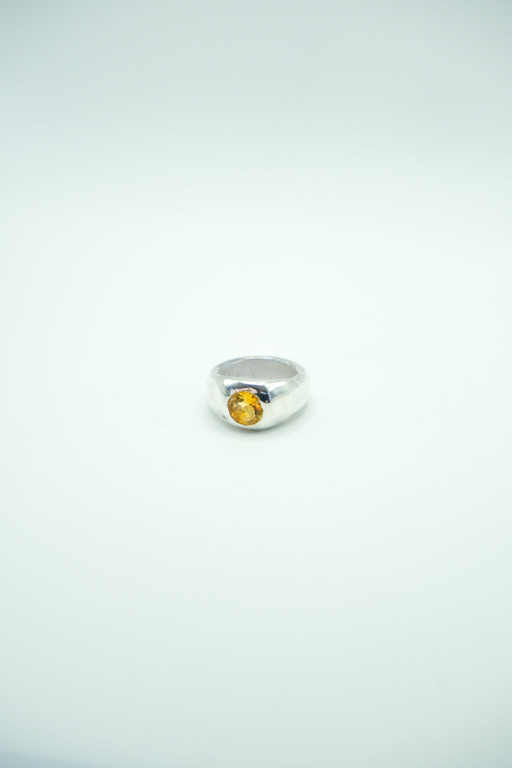 Sol and Mani Citrine Orange Stone ring featuring a large honey-colored gemstone on a silver band.