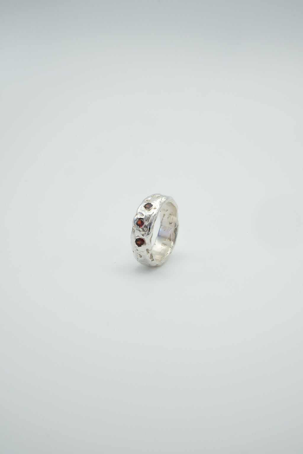 Sol and Mani Jupiter 3 red stone ring showcasing vibrant red gemstones set in a stylish silver band.