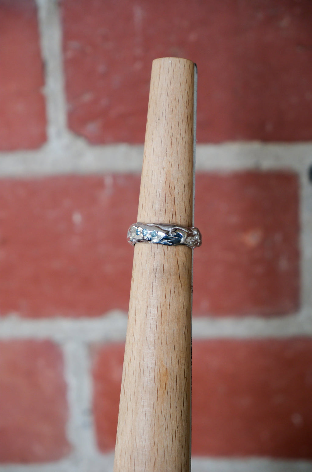 Sol and Mani Little Flower ring featuring three blue stones, delicate gold band, and floral-inspired design.