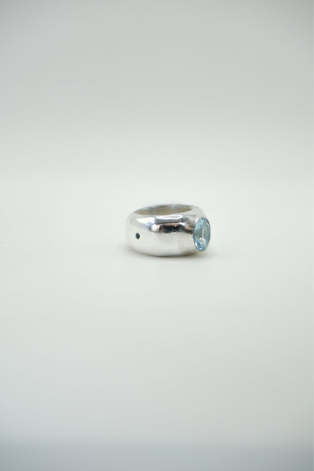 Large Sol and Mani Mira ring featuring a prominent blue topaz stone set in a stylish band.