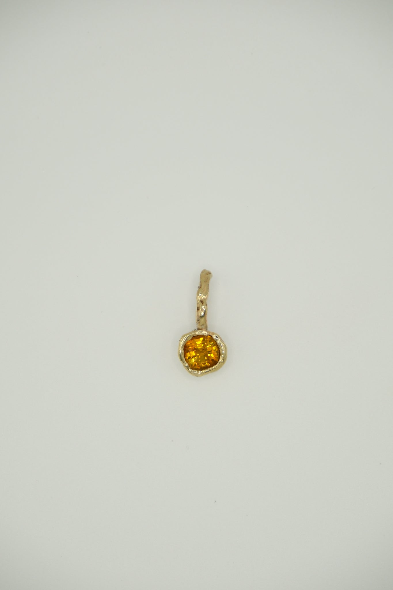 Sol and Mani June Pendant featuring a vibrant orange citrine stone set in a delicate pendant necklace.