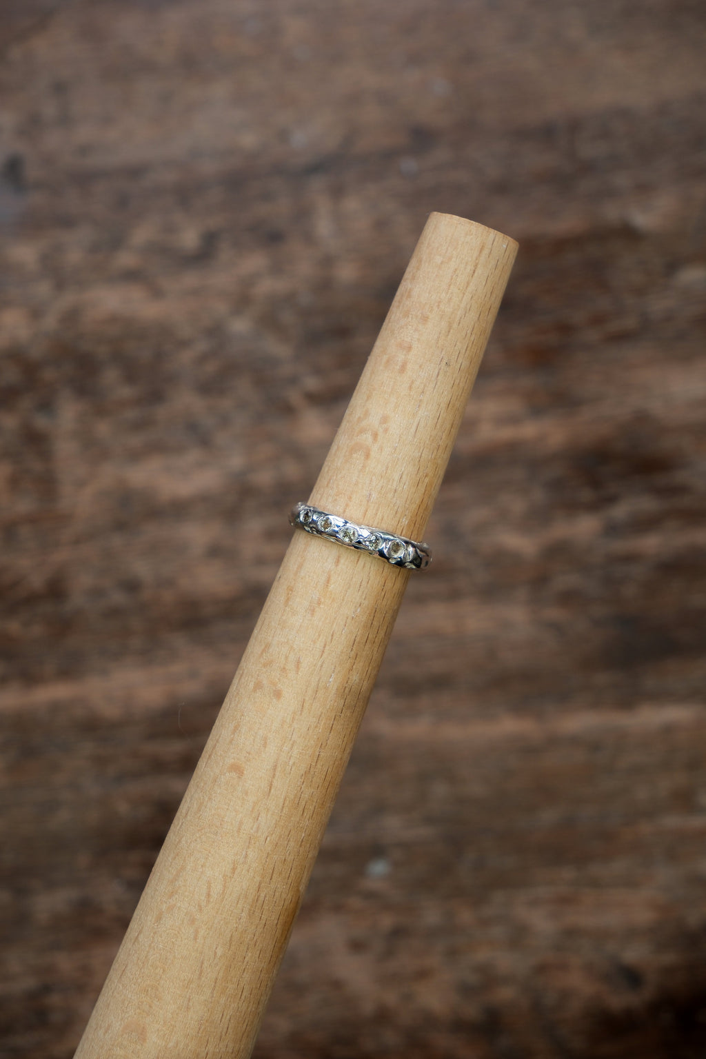 Sol and Mani small band ring with five stones, featuring a delicate design and sparkling gemstones on a silver-tone band.