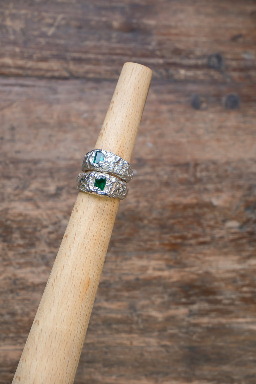 Green emerald Zephyr gemstone from Sol and Mani, showcasing a vibrant, polished emerald with intricate cut and brilliant shine.